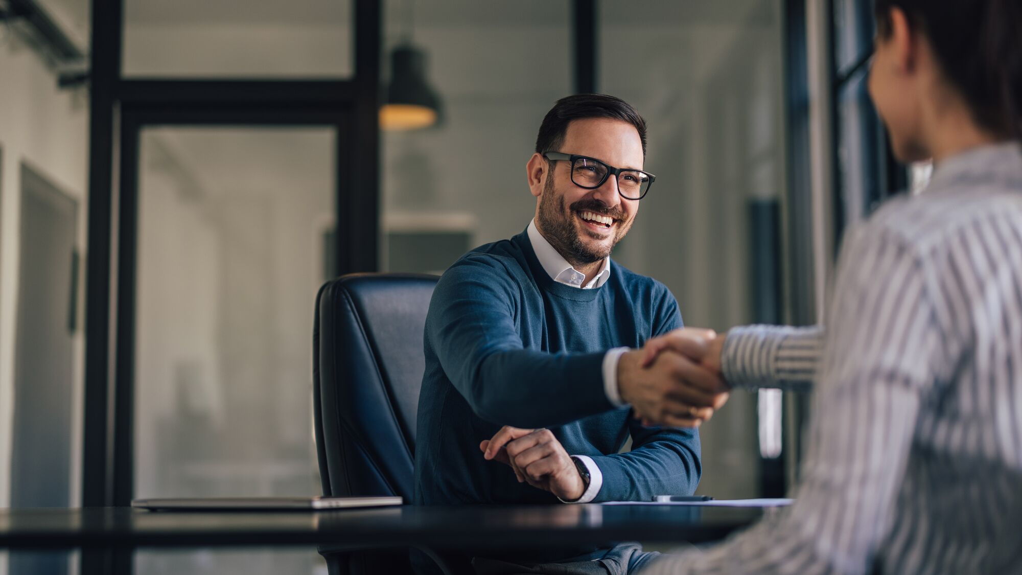 Business people, just finished the meeting, shaking hands.